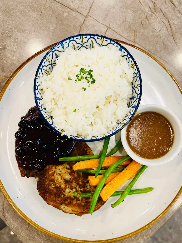 Hola Tapa & Kimchilog — tender beef tapa with salad greens, mandarin oranges, and two dipping sauces on a decorative plate