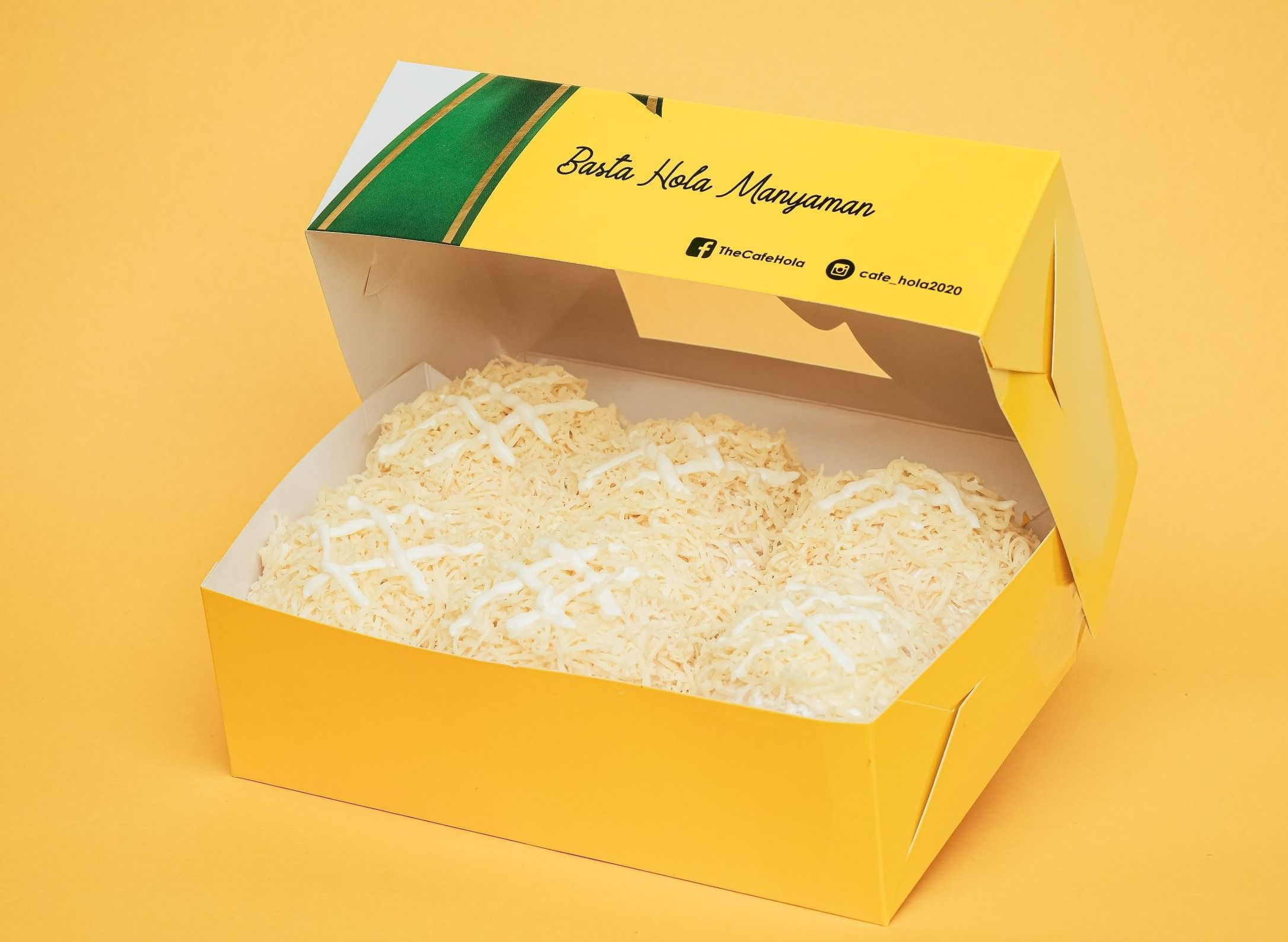 Hola Ensaymadness — six pillow-soft ensaymada rolls piled with grated cheese and cream drizzle, in an open yellow Hola box