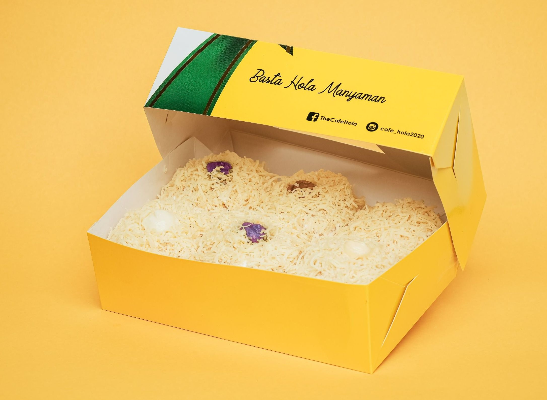 Hola Assorted Ensaymadness — six ensaymada rolls in assorted flavors blanketed in grated cheese with purple ube pieces, in an open yellow Hola box